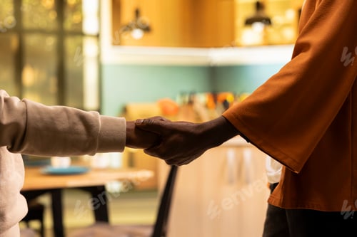 Preview: Close up of black couple holding hands in peaceful moment, after fight