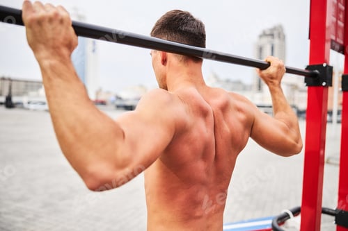 Preview: Shapely young male training upper body in open air