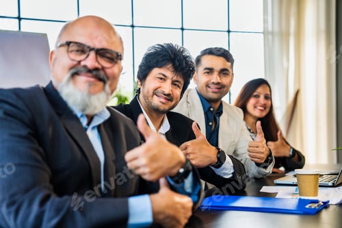 Preview: Indian Asian Business team clapping in appreciation while viewing a presentation in office setting