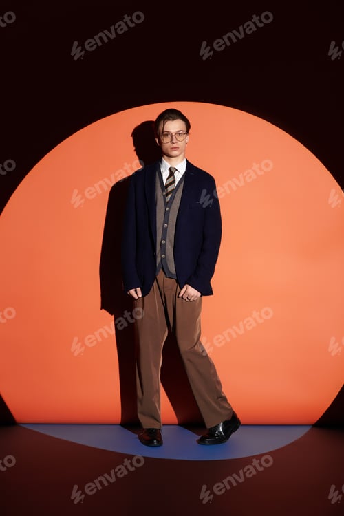 Preview: Stylish young man stands confidently against a vibrant circular backdrop in a modern setting