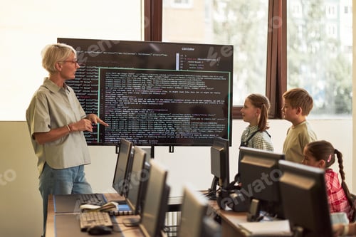 Preview: Middle Aged Caucasian Woman Teaching Group of Children Computer Programming
