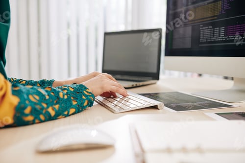 Preview: Female coder writing program