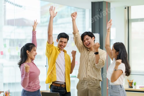 Preview: Successful group of young Asian business people achieving goals excited raised hands rejoicing.