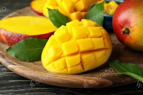 Preview: Tasty ripe mango fruit on wooden table