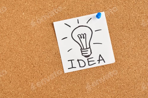 Preview: painted light bulb with word idea on a cork board