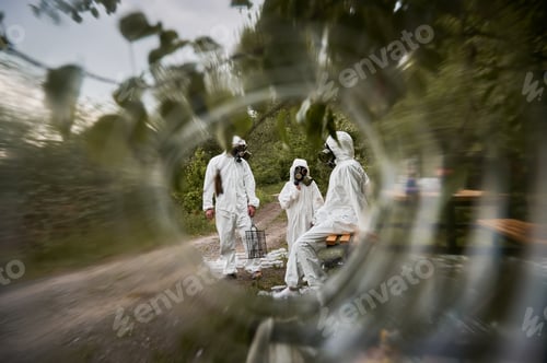 Preview: Ecologists in radiation suits in forest through blurred circle.