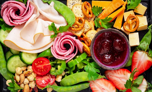 Preview: Antipasto platter cold sliced ham, salami, crackers, strawberries, vegetables and cheese platter