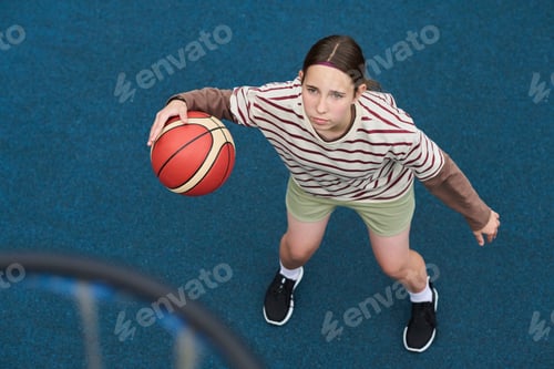 Preview: Teenage Girl Playing Streetball and Preparing to Shoot Basketball