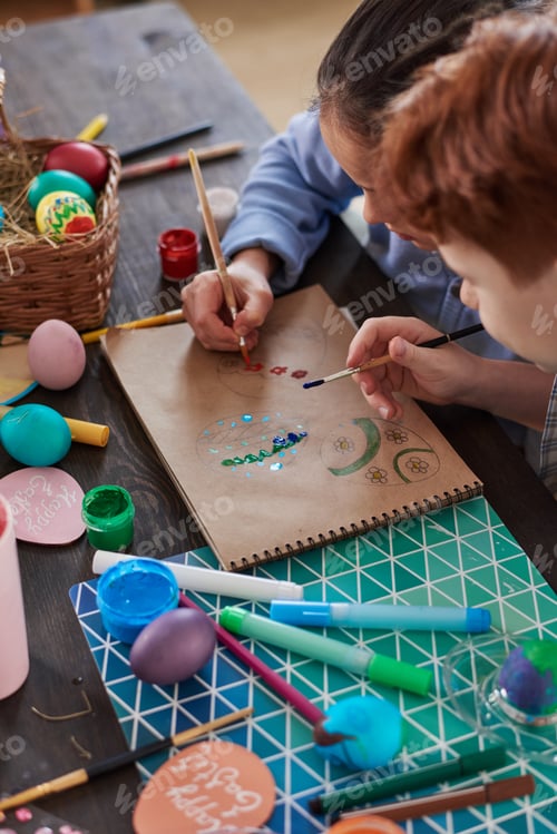 Preview: Children painting eggs at the table