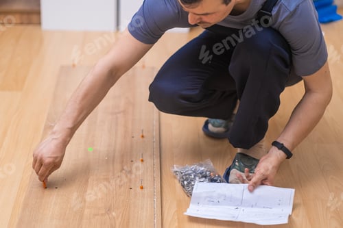 Preview: Carpentry business handyman twisting nail into wooden cabinet to attach shelves