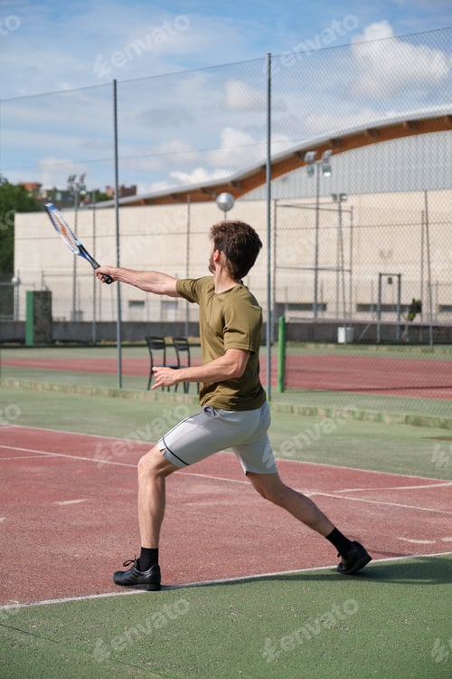 Preview: Tennis player is serving the ball on a sunny day