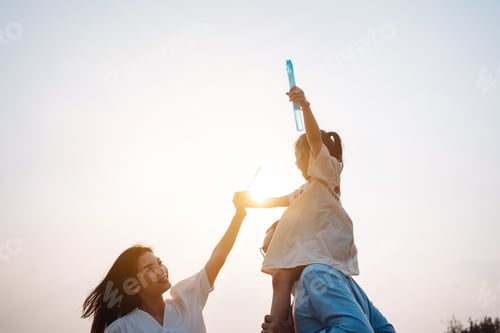 Preview: Happy family in the park sunset light. family on weekend running together