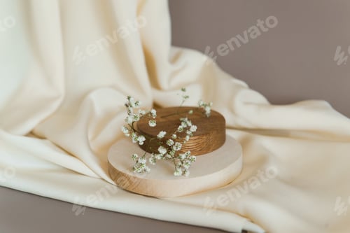 Preview: Empty wooden podium gray background. Product presentation with flowers, silk cloth and leaves