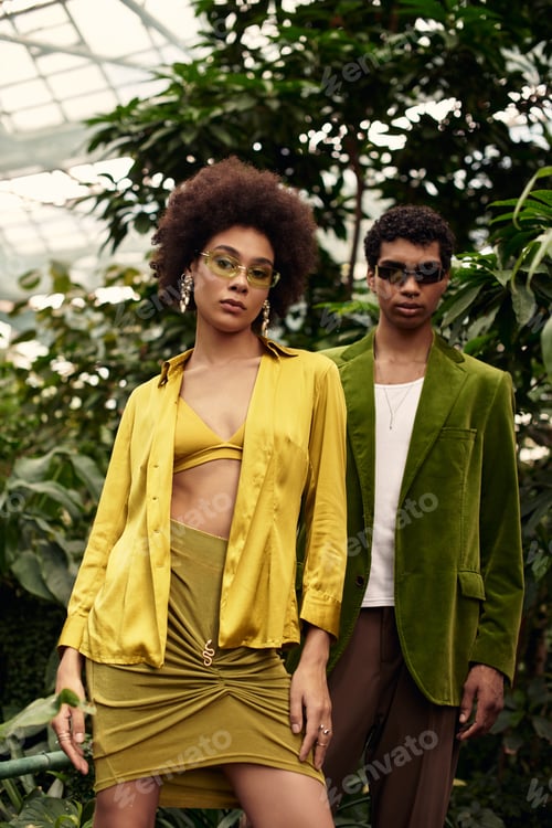Preview: Young couple enjoys a romantic moment surrounded by lush greenery in a vibrant greenhouse