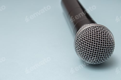 Preview: Closeup shot of a microphone on a blue background