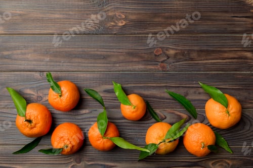 Preview: Many fresh ripe mandarin with green leaves on colored background, top view, space for text