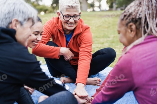 Preview: Multiracial people stacking hands outdoor - Focus on center senior woman face