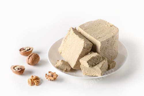 Preview: Walnuts halva in plate isolated on white.