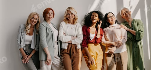 Preview: Multi-ethnic group of relaxed mature women bonding and smiling while leaning on the wall
