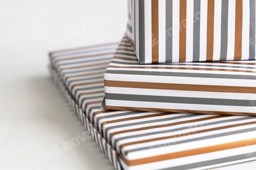 Preview: Presents Wrapped in striped paper on white table close up