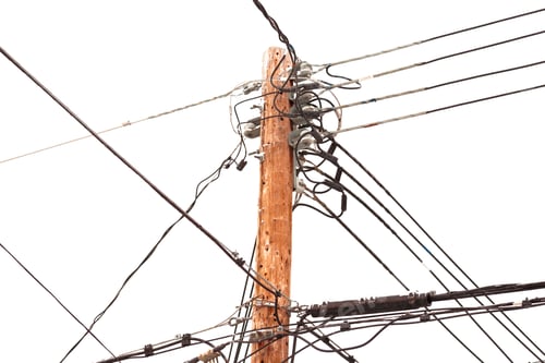 Wooden Utility Pole with Wires Against White Background