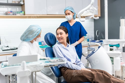 Preview: Caucasian dentist examine tooth for young girl at dental health clinic.