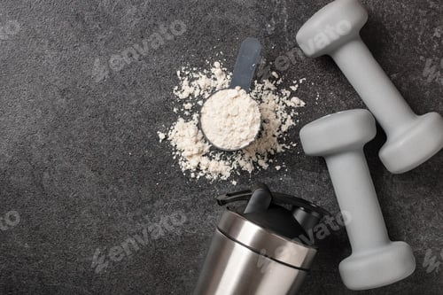 Preview: Whey protein powder, shaker and dumbbells on black