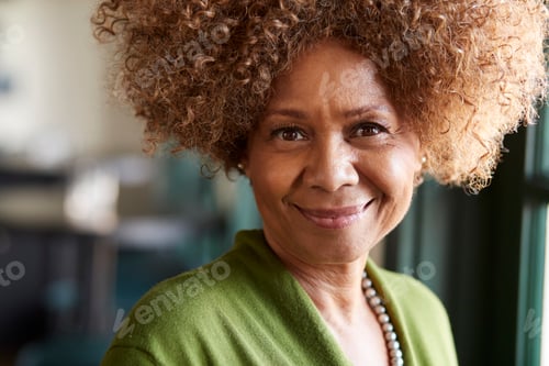 Preview: Portrait Of Smiling Senior Woman Sitting In Restaurant