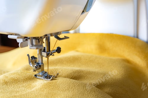 Preview: Modern sewing machine and yellow fabric. Sewing process, handmade, hobby, DIY, business, repair