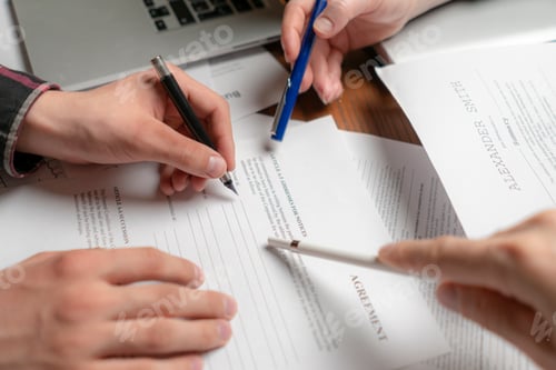 Preview: close up photo of crew of businessmen signing documents