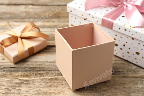 Preview: Opened and closed gift boxes on wooden table, closeup