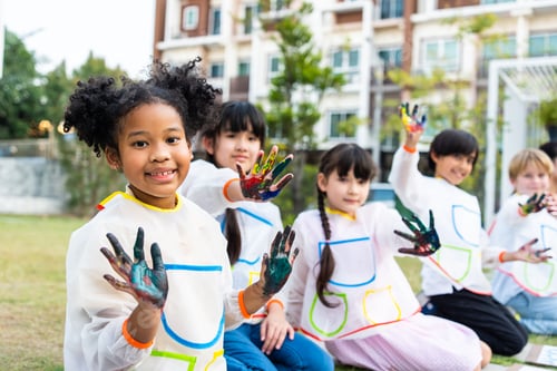 Preview: Group of student coloring on painting board outdoors in school garden. A