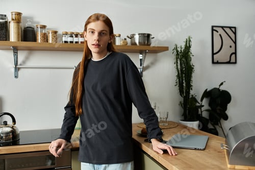 Preview: A young man with long red hair relaxes in his stylish apartment, enjoying a cozy moment.