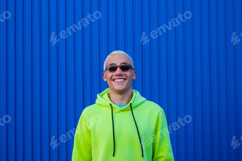 Preview: one happy and crazy man wearing fashion glasses smiling and having fun looking at the camera