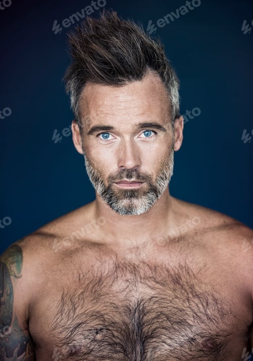 Preview: Hes got rugged confidence. Portrait of mature man posing against a dark background.