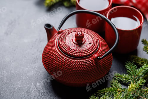 Preview: Teapot, cup, and fir tree branches create a cozy scene