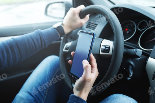 Preview: Male hands with phone. Man in car is using smartphone.