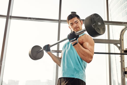 Preview: Close up of man using dumbbell exercise at gym, Sport concept.