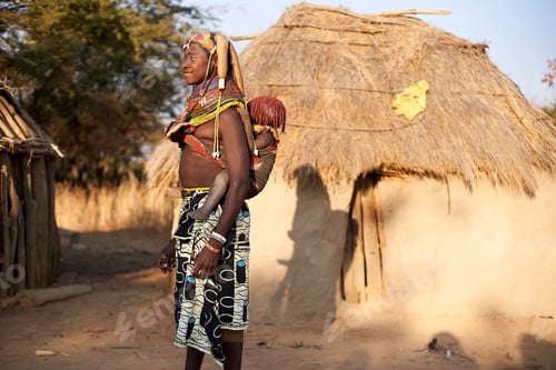 Preview: Muhila tribe woman carrying her child on her back, Kehamba, Chibia, Angola