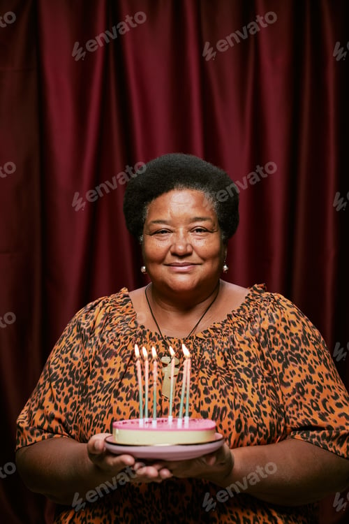 Preview: Portrait of Middle Aged Black Woman Smiling Holding Birthday Cake in Photo Booth
