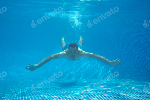 Preview: Underwater View Of Man Swimming In Pool On Summer Vacation