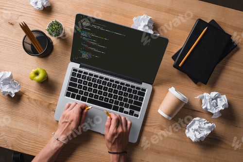 Preview: cropped shot of businessman breaking pencil while looking at code on screen at workplace