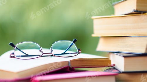 Preview: pile of old books lie on the table. home library. concept of vacation from gadgets in nature
