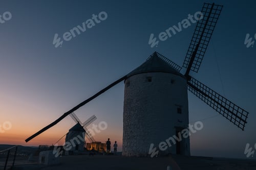 Preview: A windmill tower is silhouetted against the sky at dusk
