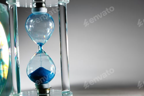 Preview: Blue hourglass on gray background close up