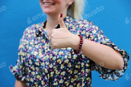 Preview: Woman Giving Thumbs Up Wearing Floral Blouse
