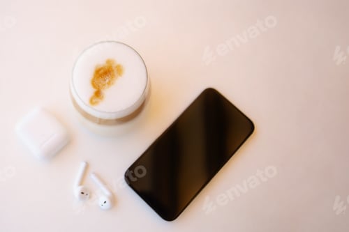 Preview: Top view from coffee cup,headphones and smartphone.Background with copy space.