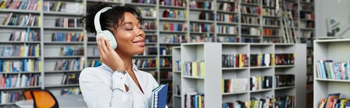 Preview: Inspiring African American teacher enjoying music while immersed in education at a vibrant library