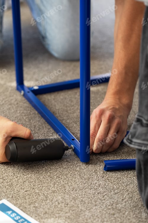Preview: Diy furniture assembly scene with hands and instructions for home improvement