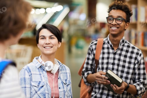 Preview: Pleased hipster students in library